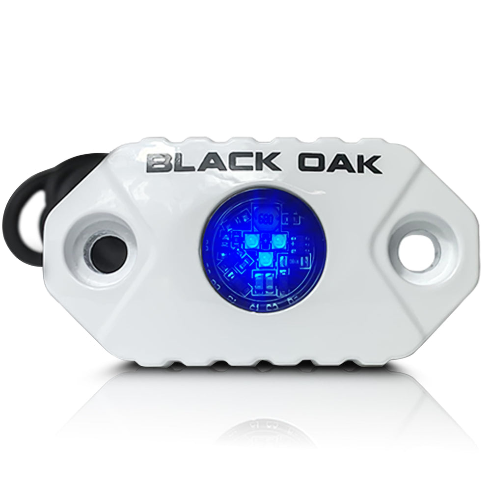 Black Oak front view puck light showing blue glow and durable housing for visibility