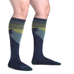 Darn Tough over-the-calf length beside ruler showing coverage