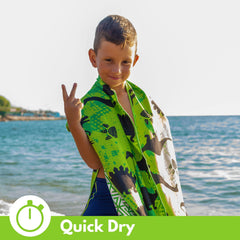 ECCOSOPHY towel in use wrapping toddler at beach for warmth and sand-free comfort