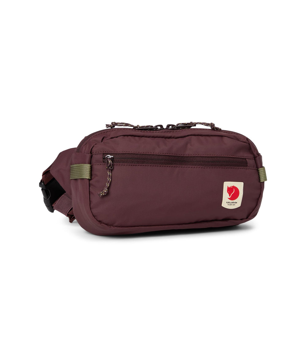 Fjällräven High Coast hip pack front view in blackberry showing compact profile and zippered pockets for secure storage