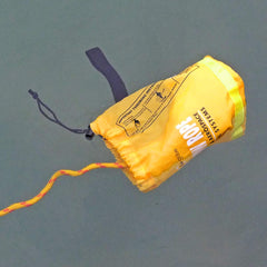 Goglobe in use being thrown from a kayak to a swimmer for safer rescue reach