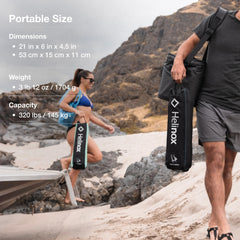 Helinox beach chair in use on sand delivering low-profile comfortable lounging