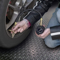 JACO BikePro held in hand demonstrating sturdy brass build and readable dial