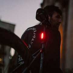 KNOG Plus clipped to jacket demonstrating wearable visibility benefit