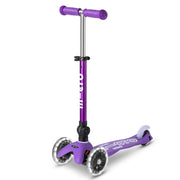 Micro front view of folded scooter showing compact portability and easy carry