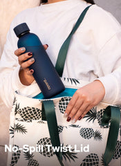 Opard bottle beside hand and phone demonstrating 27oz size and portable scale