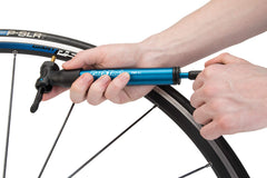 Park Tool mini pump seated in bottle cage showing space-saving storage benefit