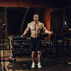 Proud Panda athlete using heavy jump rope in gym for power training