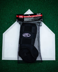 Rawlings leg guard beside bat for scale showing adult size fit
