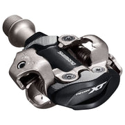 Shimano PD-M8100 front view showing dual-sided pedals and stable platform for secure contact