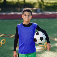 Sintege kids wearing pinnies during match showing clear team separation and mobility