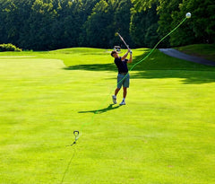 SWING AWAY! close view of iron striking a real ball illustrating true contact feedback