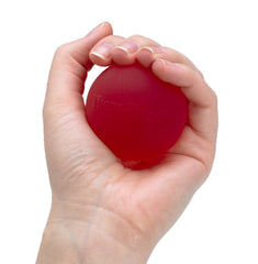 THERABAND red hand exerciser front view showing soft texture and labeled compression level for gentle grip training