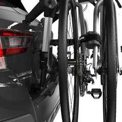 Thule bike protector mounted on car rack securing two bikes during transport