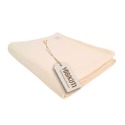 Yogikuti front view folded blanket showing neat fold and portability benefit