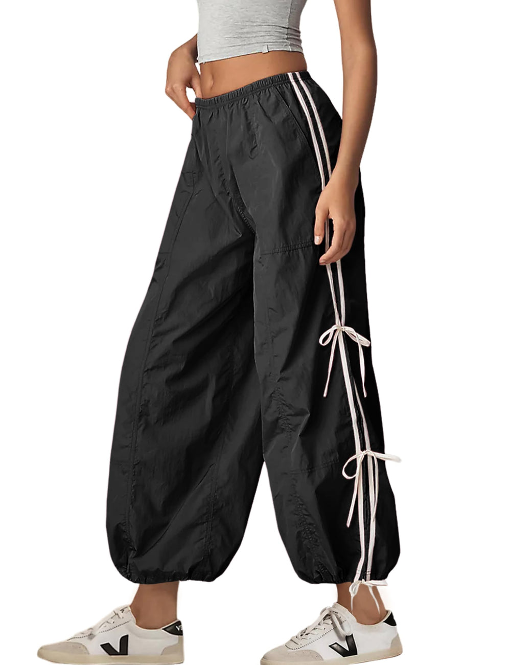 Zhiyouni front view of black parachute pants showing relaxed fit and pockets for easy styling