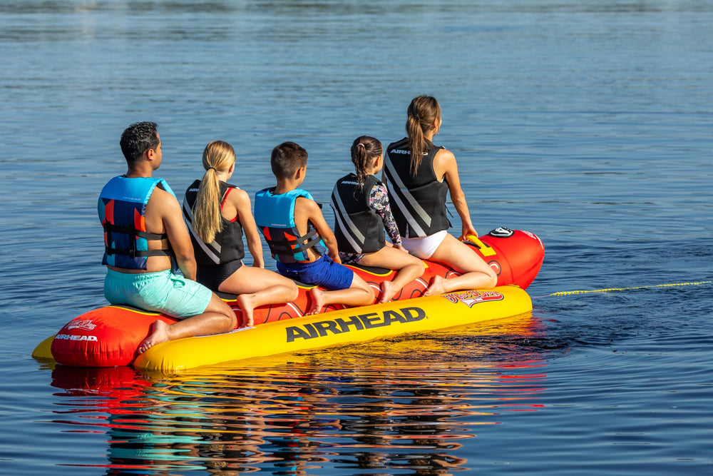 AIRHEAD Jumbo Dog size comparison with person showing scale and capacity for five riders