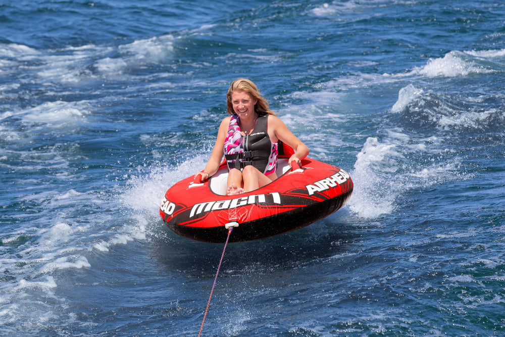 AIRHEAD Mach 1 next to paddle for scale, illustrates compact one-person size
