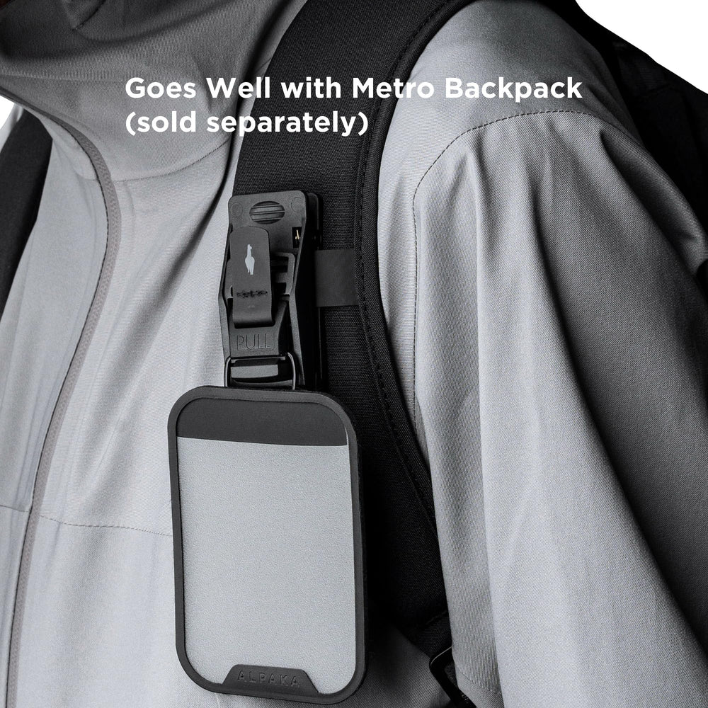 ALPAKA HUB clipped on backpack in lifestyle scene showing rugged everyday use