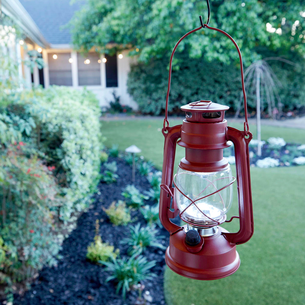 Alpine Corporation lit red lantern at night offering bright cool-white illumination