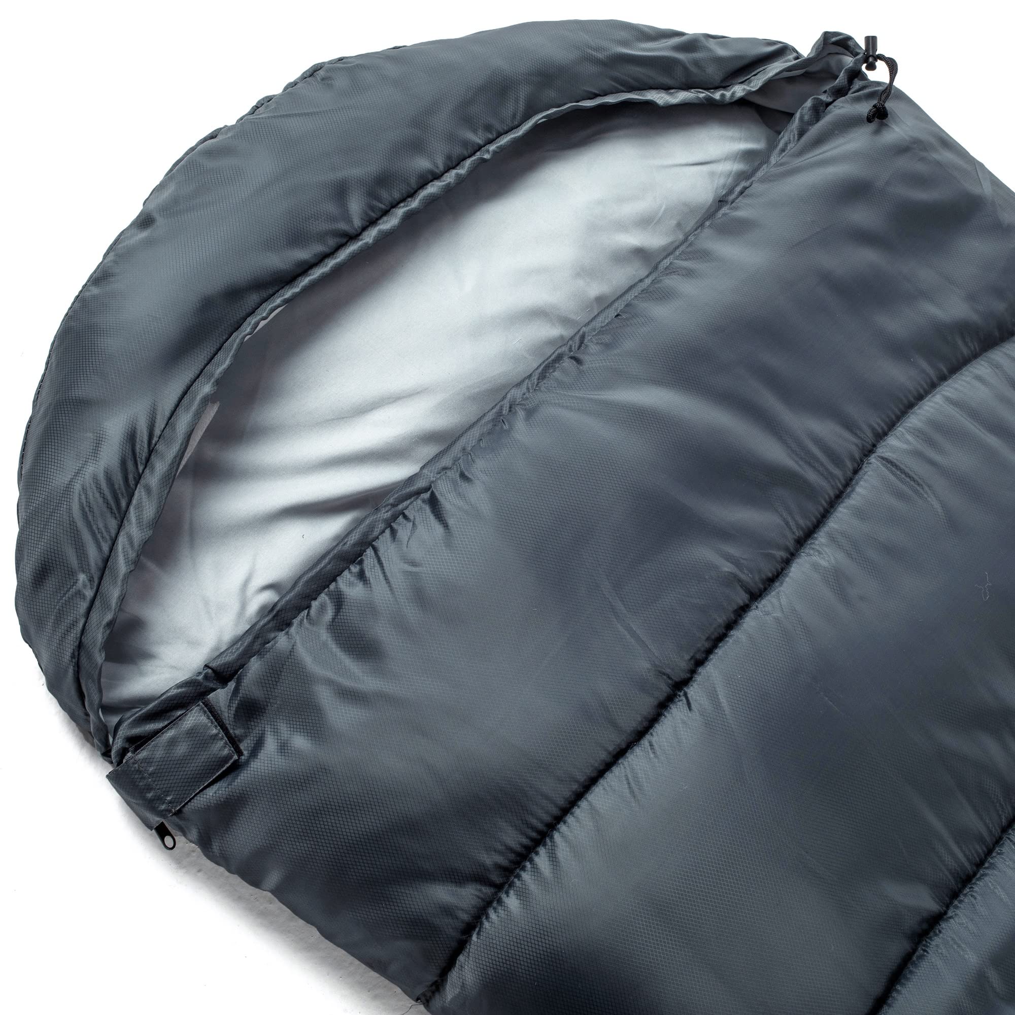 Alpine Swiss sleeping bag beside backpack to show packed size and portability