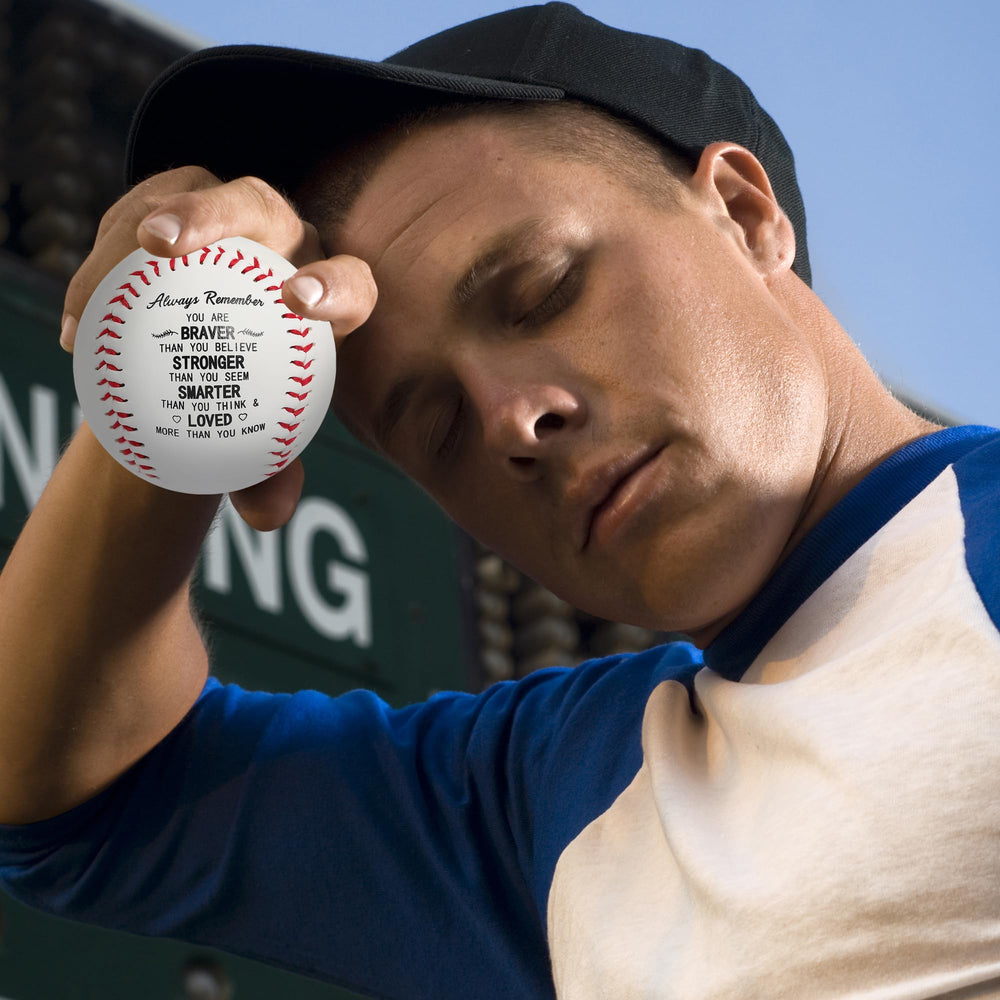 AMAZINGSUN baseball next to a hand for scale, illustrates official size and weight