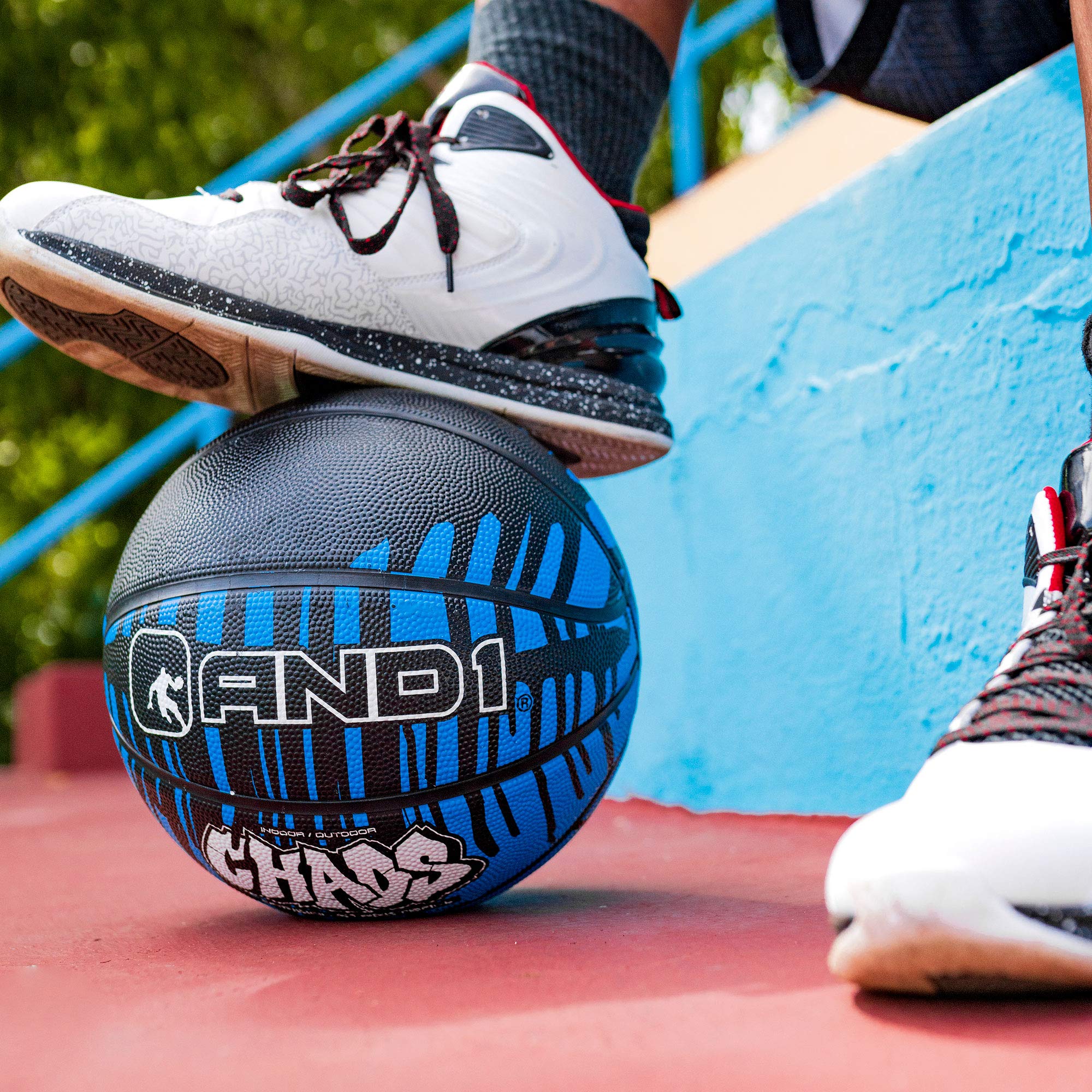 AND1 basketball on court next to player illustrating style and versatile play benefit