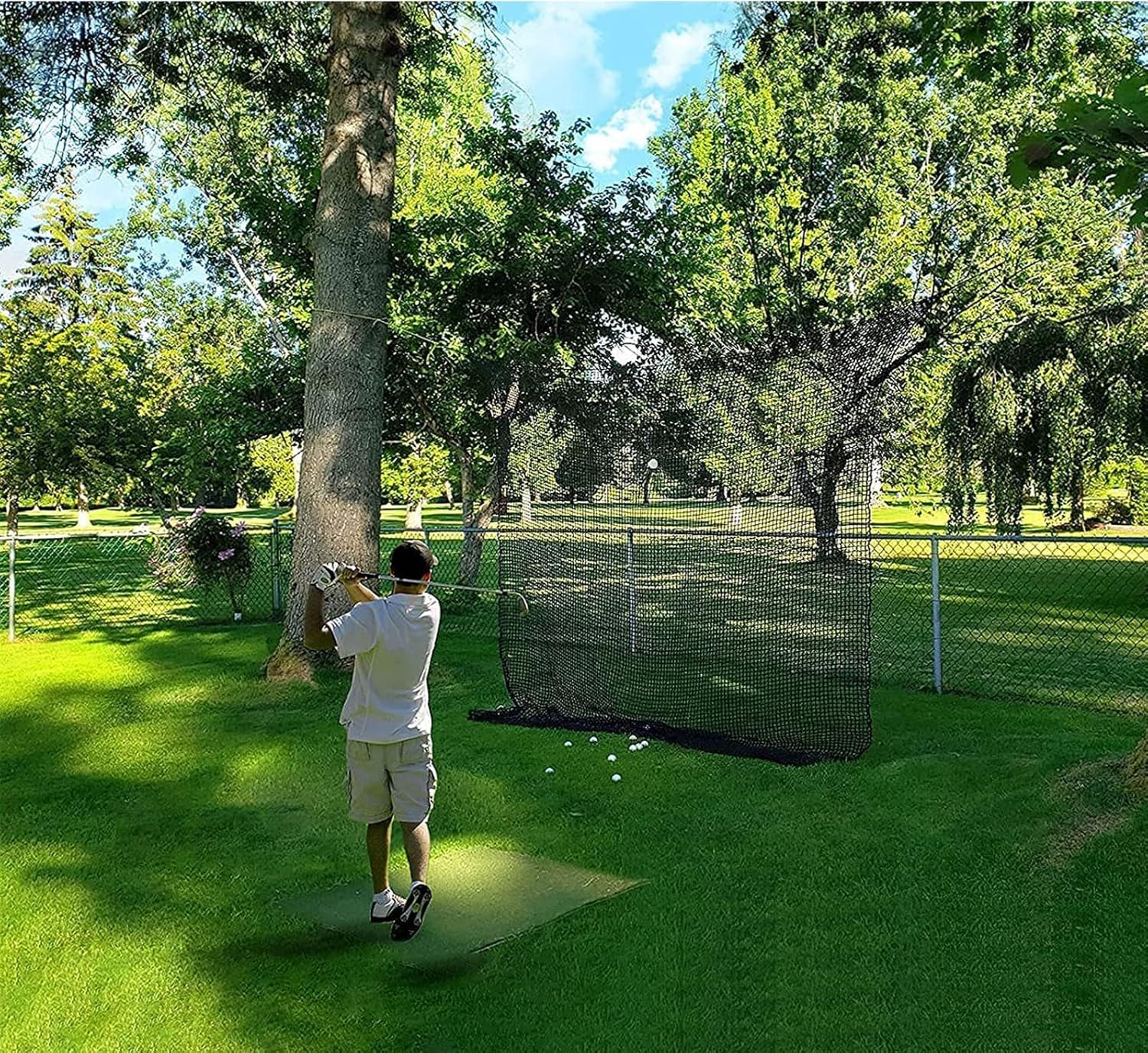 Aoneky net hung in a backyard capturing golf balls for safe practice benefit