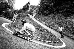 Atlas Truck Co trucks mounted on longboard in action showing responsive carving benefit