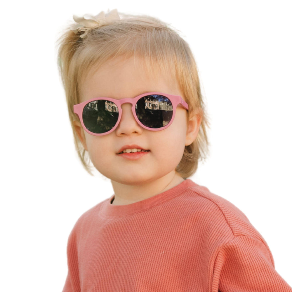 Babiators baby wearing Moon Cherry sunglasses outdoors for protected, comfortable play