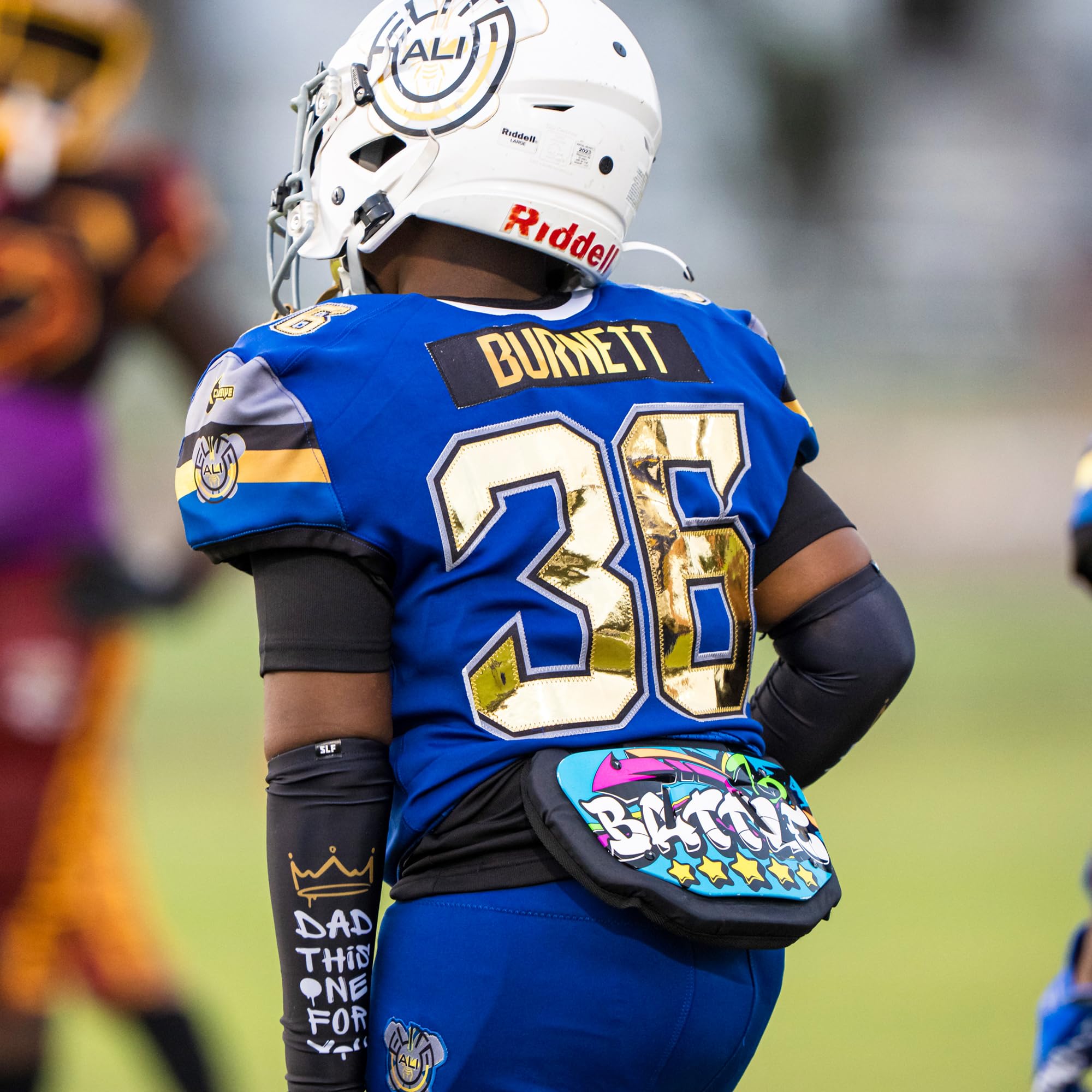 Battle back plate on player during game demonstrating secure fit and mobility