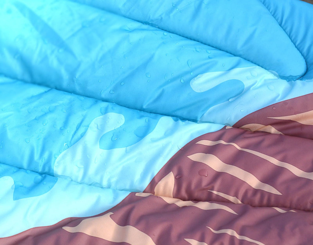 Bedvcaty blanket in use at a picnic offering comfortable ground insulation