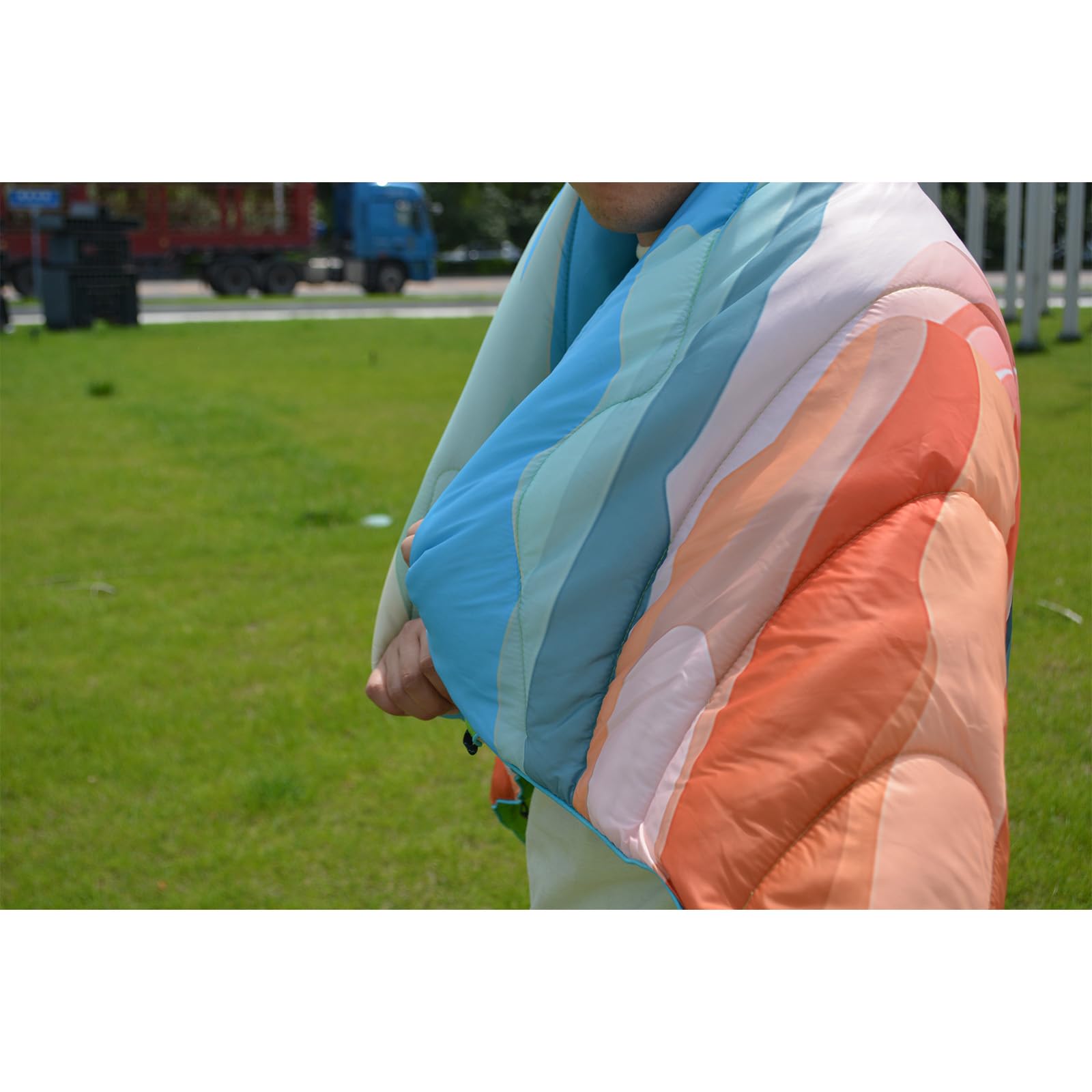 Bedvcaty blanket repelling water on grass, keeps you dry outdoors