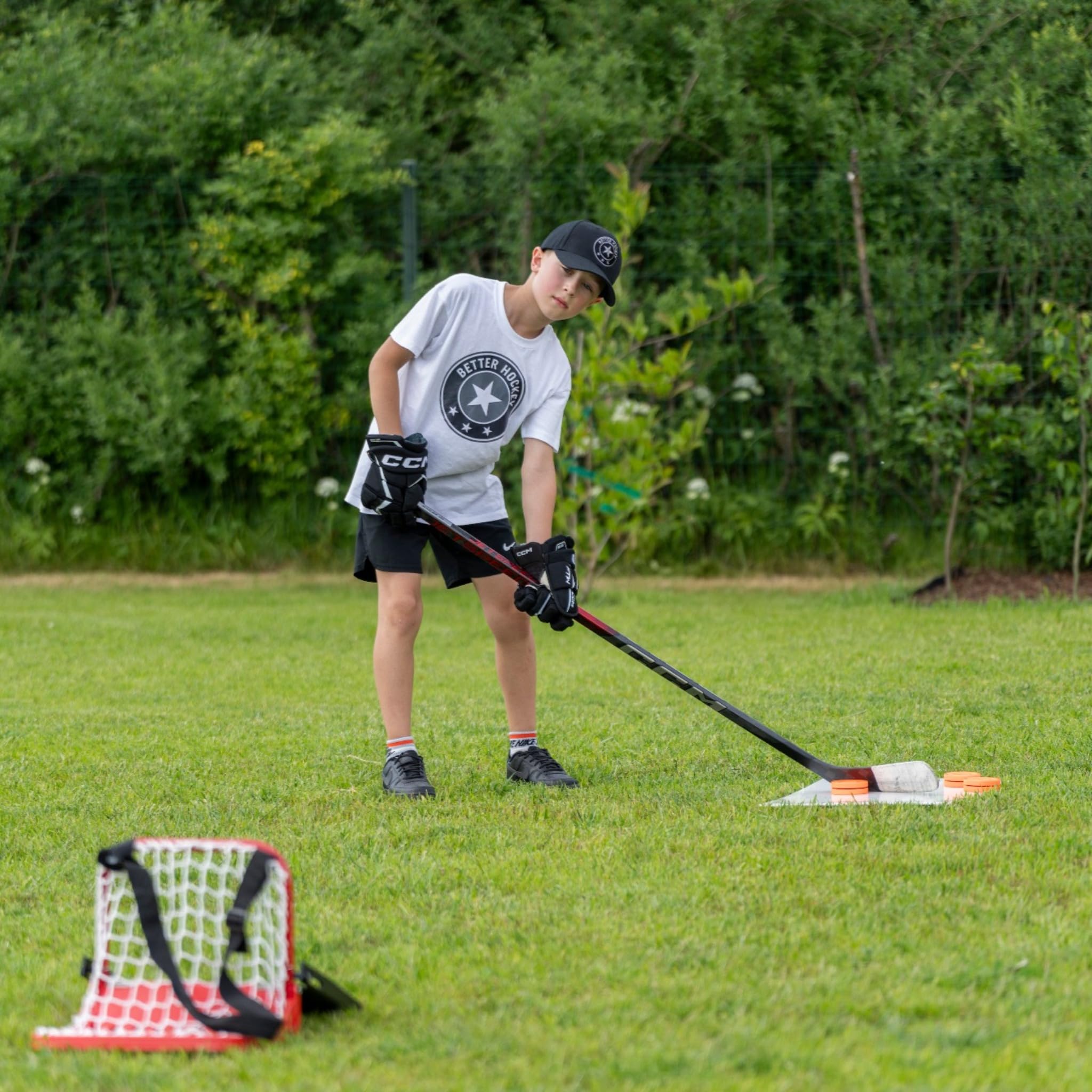 Better Hockey stick and puck on pad showing improved puck control while protecting sticks