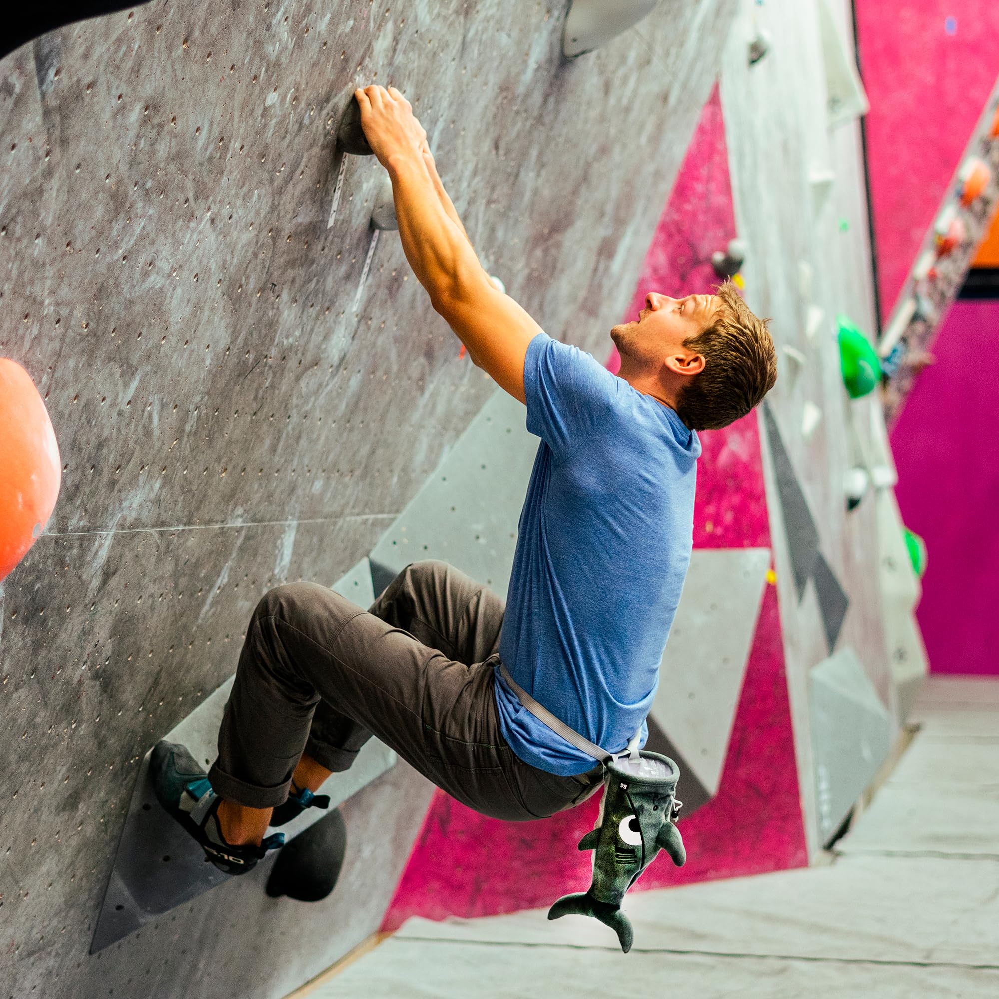 BG Climbing chalk bag on gym floor with climber preparing for route benefit
