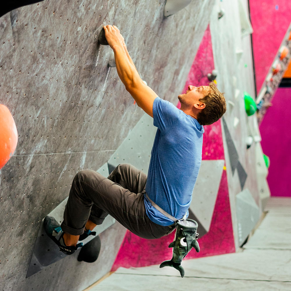 BG Climbing chalk bag on gym floor with climber preparing for route benefit