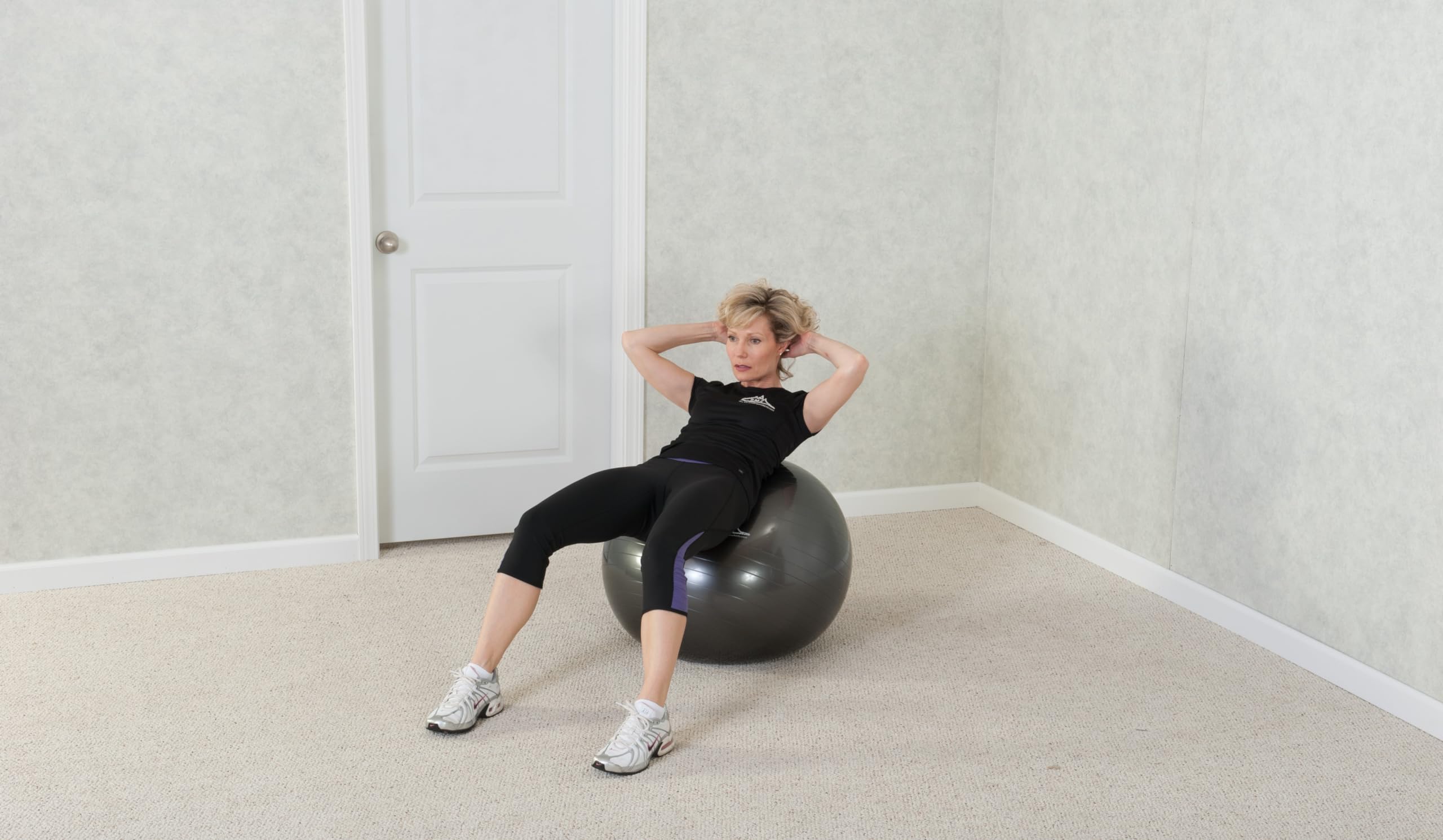 Black Mountain Products ball used as office seat demonstrating improved posture benefit