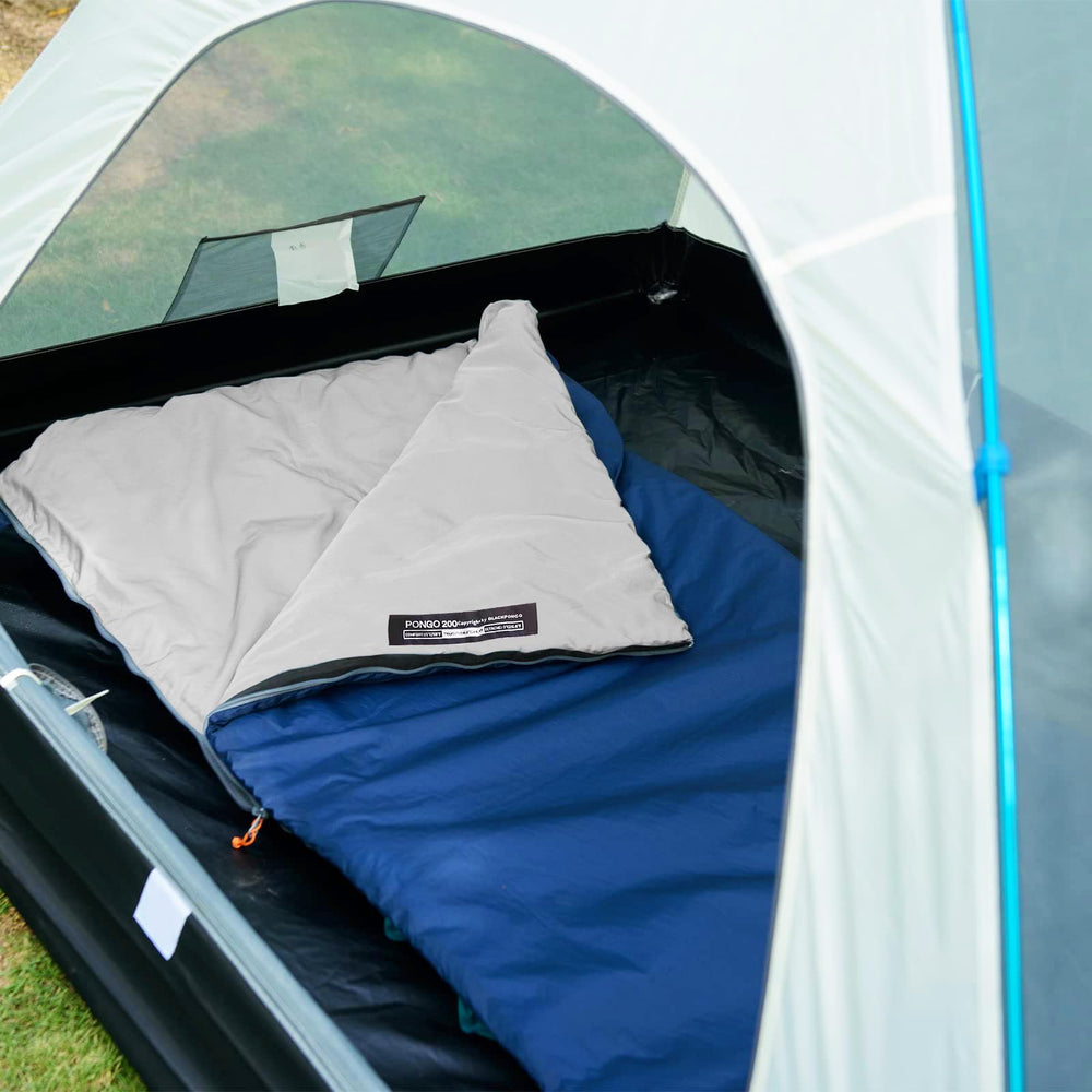 Blackpongo in use at a campsite at night illustrating warmth and practicality for three-season trips