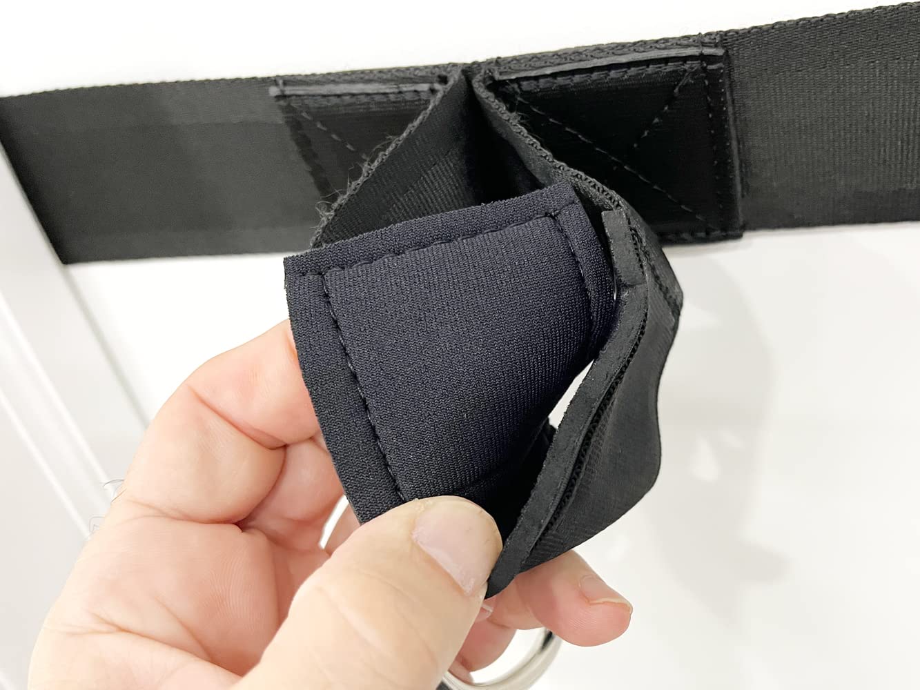 bodylastics Ultra Anchor pictured next to handle showing compact size and portability benefit