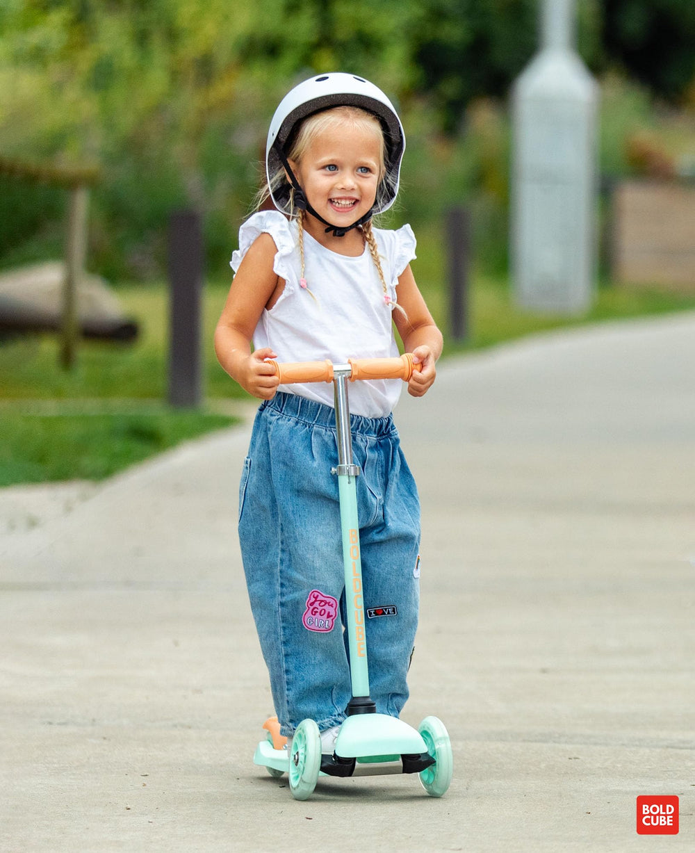 BOLDCUBE child riding on pavement illustrating balance development and fun