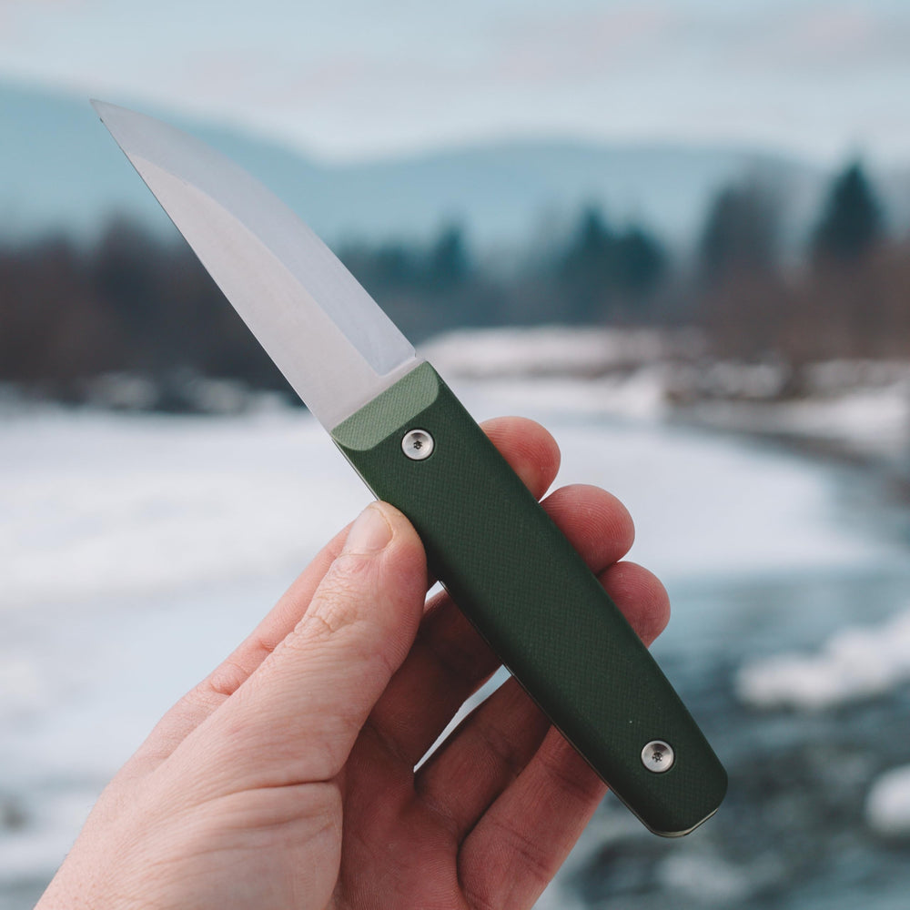 BPSKNIVES Aurora held in hand for scale, demonstrates compact carry benefit