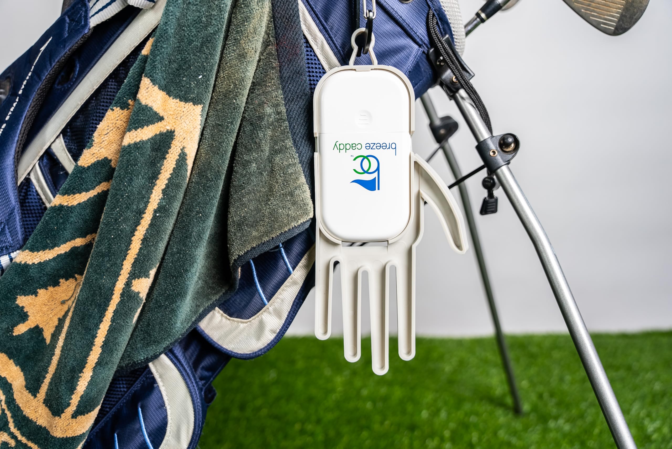 Golfer using Breeze Caddy on fairway for dryer gloves and on-course cooling