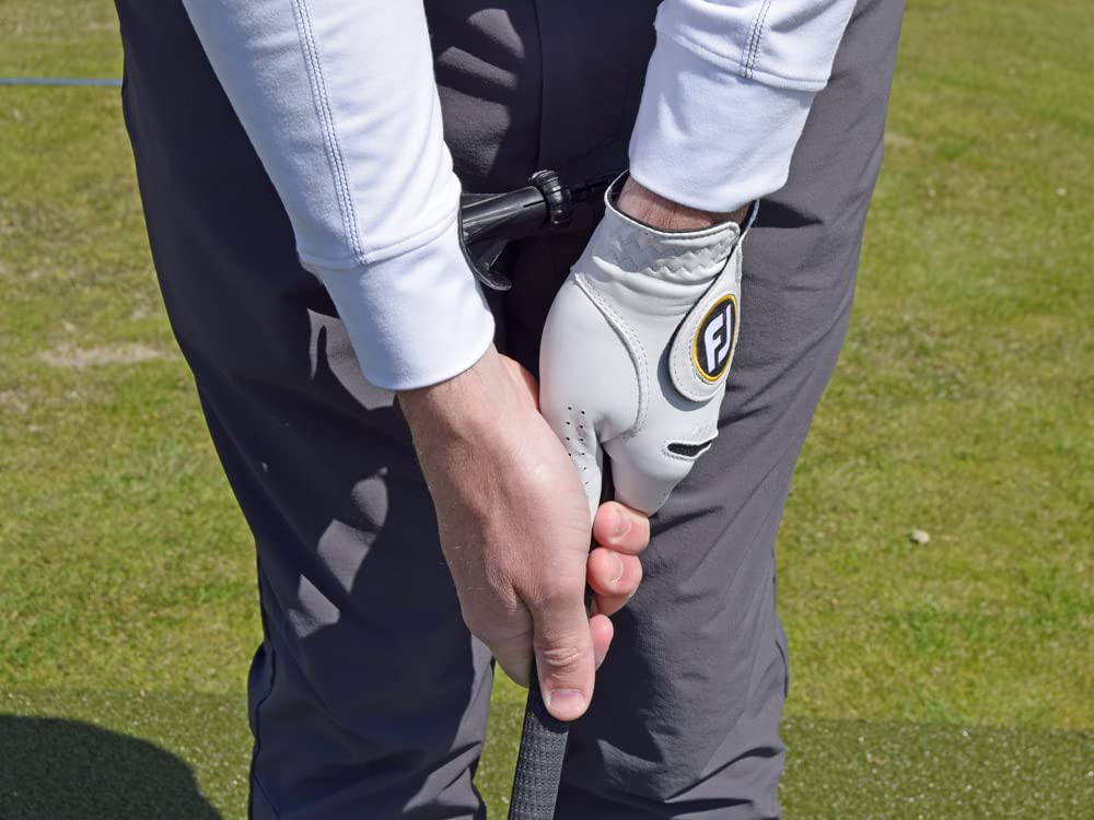 Left-handed golfer on course using Brunton GripIt Rite to reinforce setup
