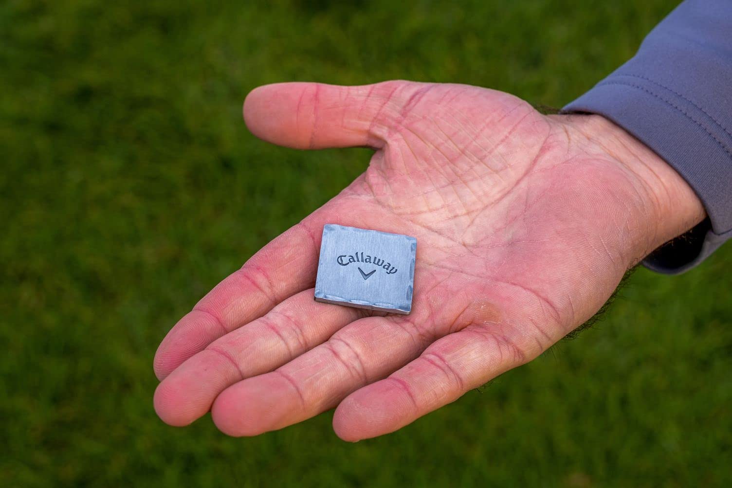 Izzo Callaway kit size comparison with hand showing compact, portable course convenience