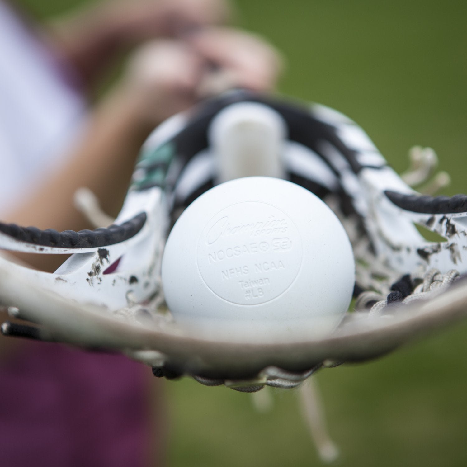 Champion Sports lacrosse ball with scuff marks showing long-lasting resilience benefit