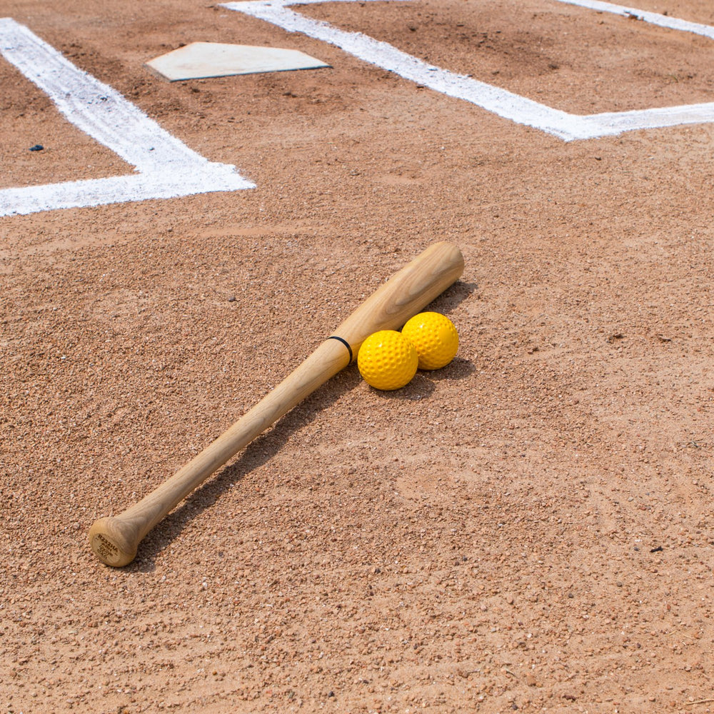 Champion Sports ball in mid-swing during batting practice to improve reps