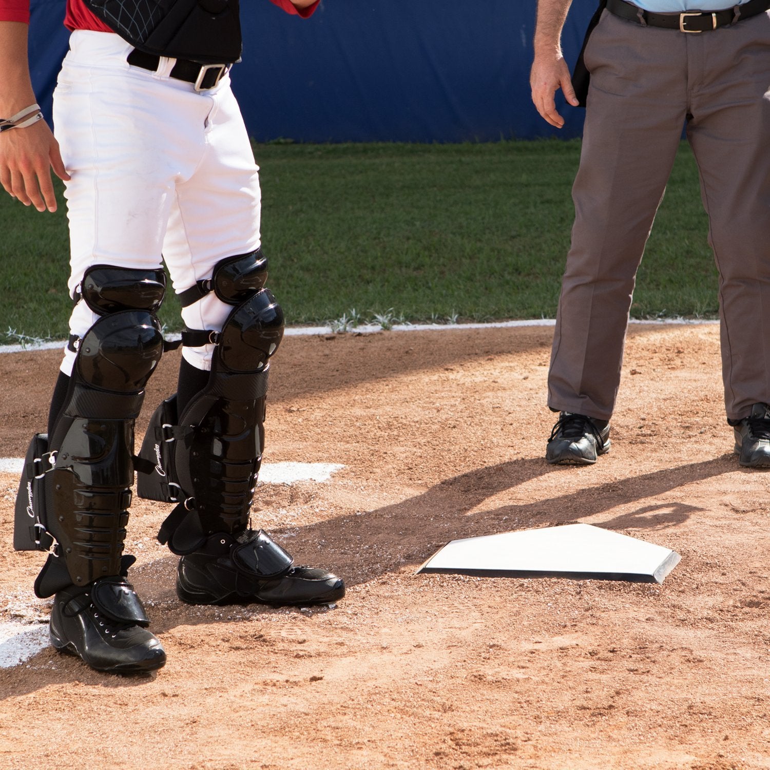 Champion Sports home plate next to ruler for scale showing compact, regulation-friendly size
