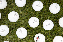 Clean Green Golf Balls single Titleist Pro V1 held in hand to show size and scale for play
