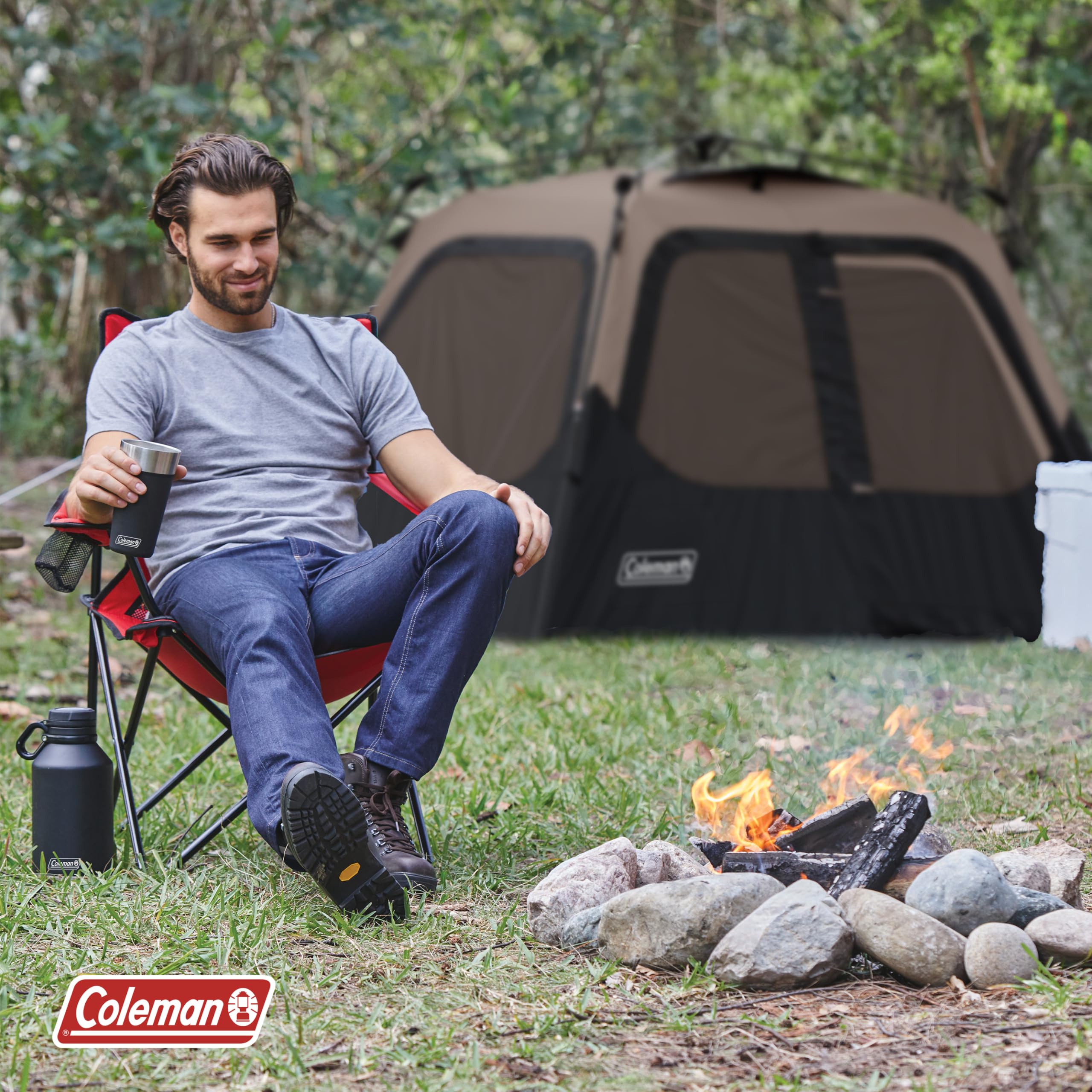 Coleman tent at campsite near campfire illustrating easy setup and outdoor comfort
