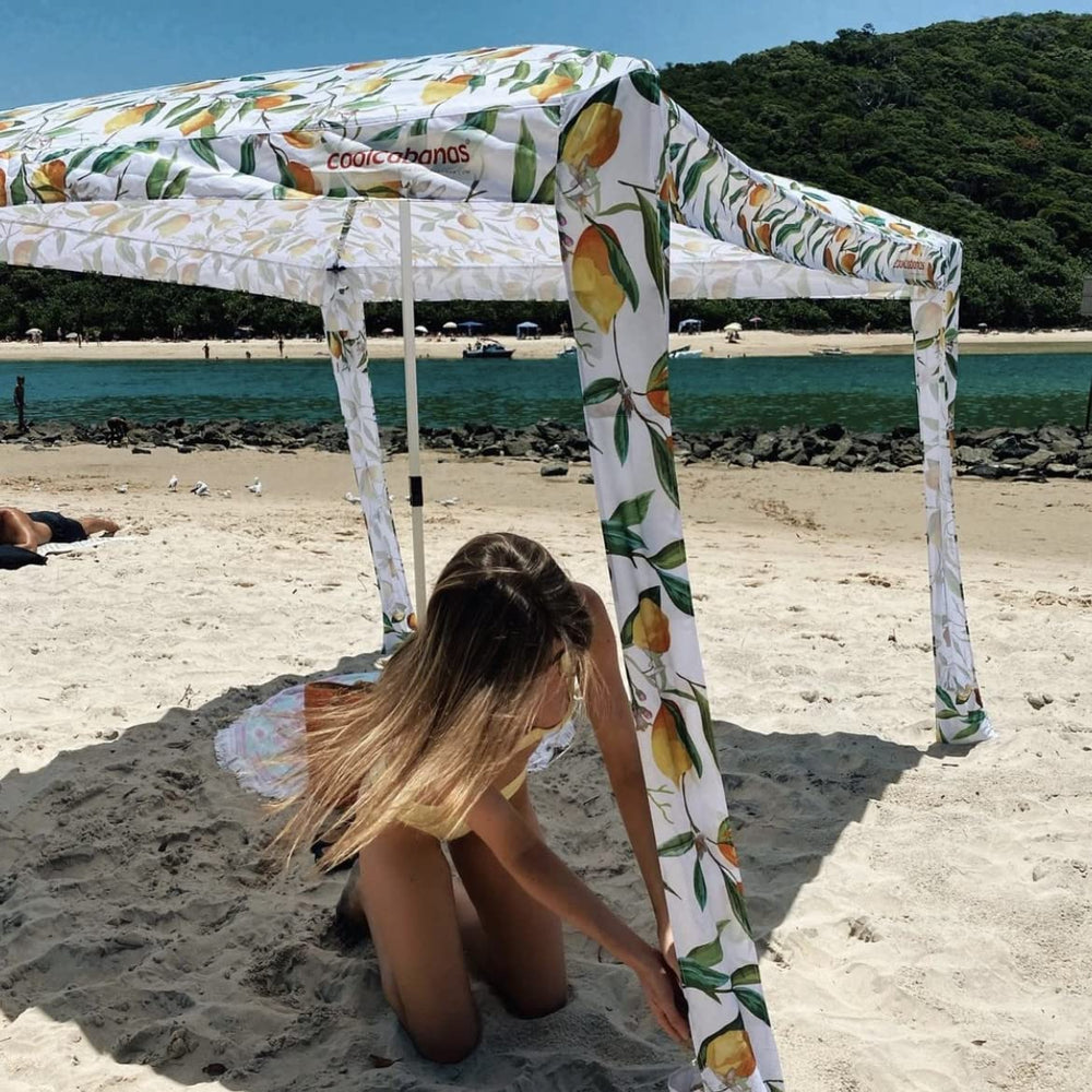 CoolCabanas with family relaxing under shade demonstrating roomy coverage